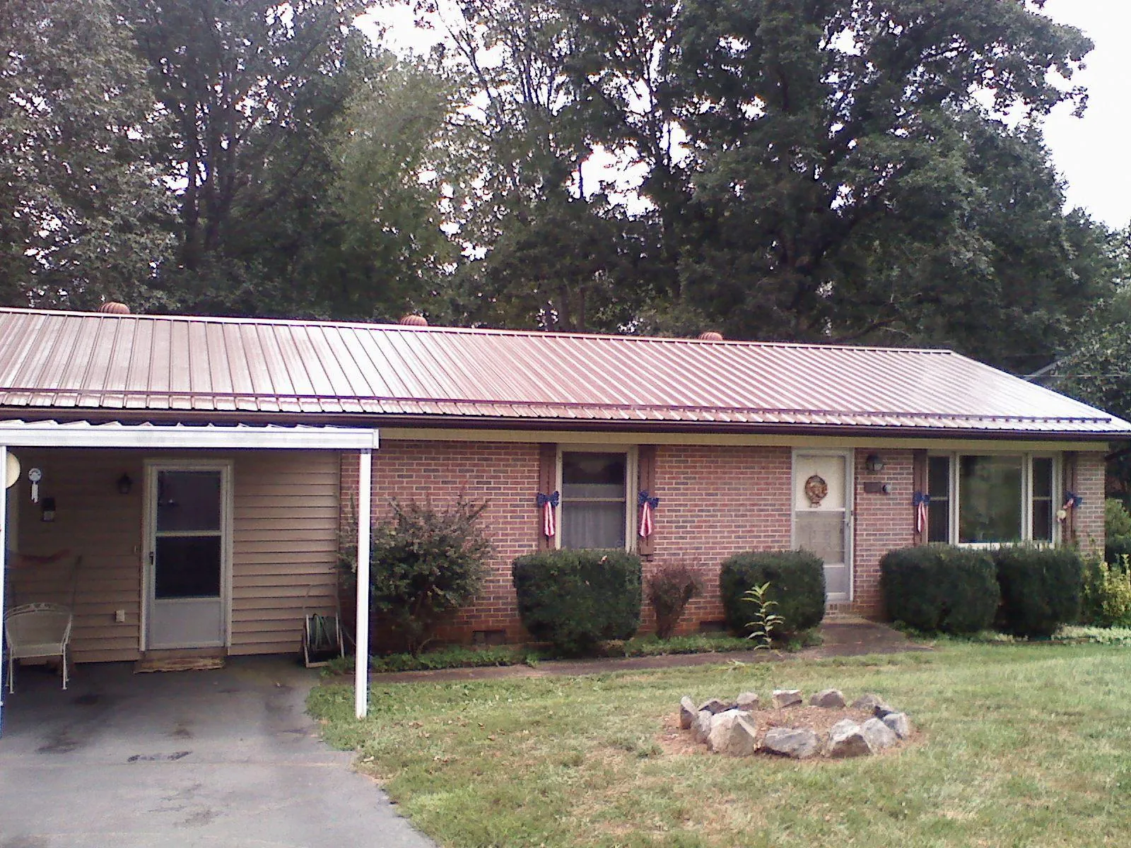 Bronze metal roof and carport on a brick ranch home — Roof Repair work by our crew in Mt Baldy