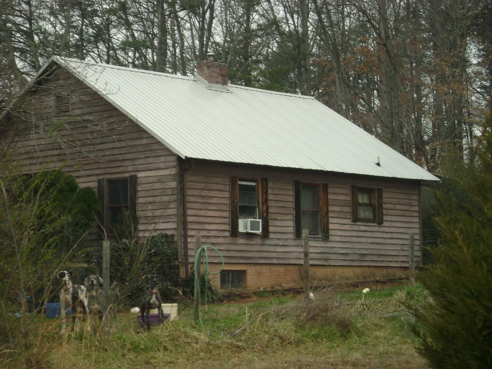White metal roof on an old wood sided farmhouse, from a Metal Roof Installation job in Mt Baldy